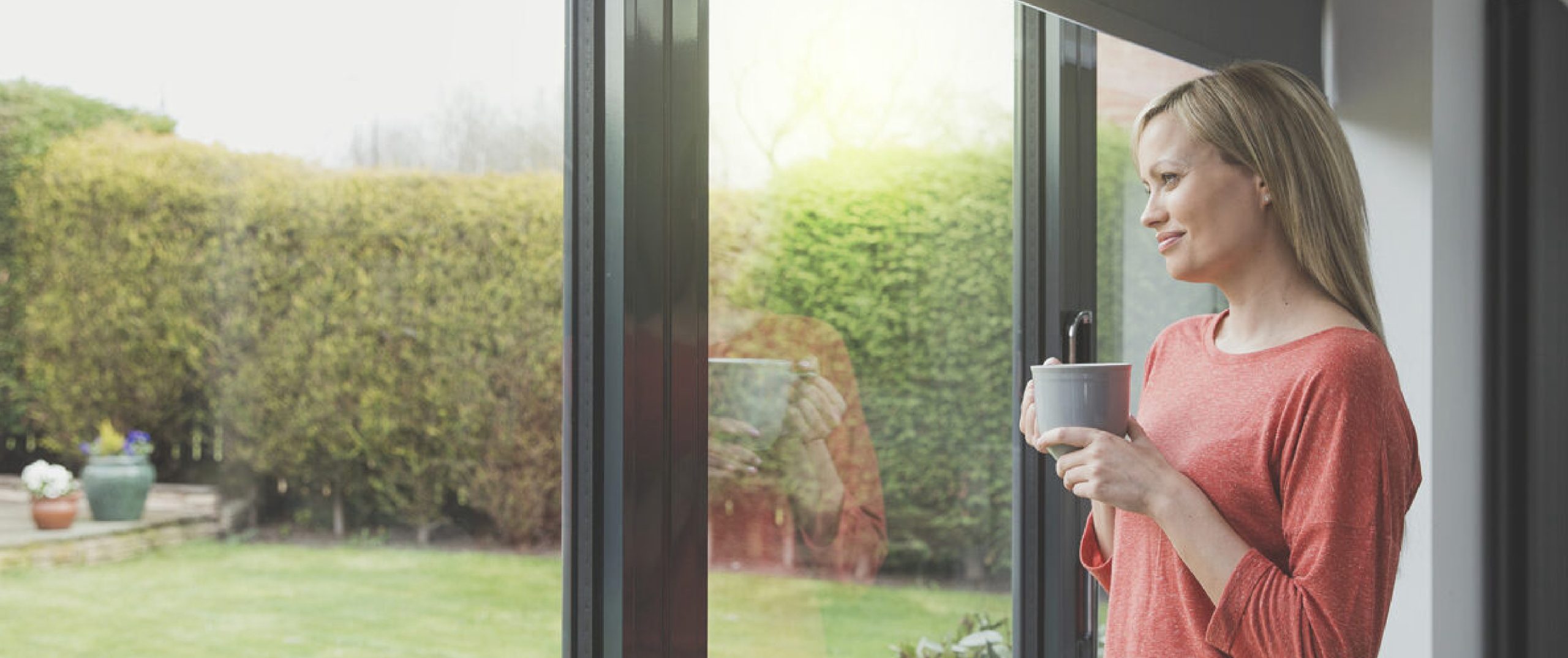 Lady drinks coffee and watching through windows and doors